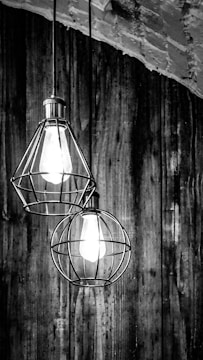 An industrial retro pendant light hanging above a rustic wooden table.
