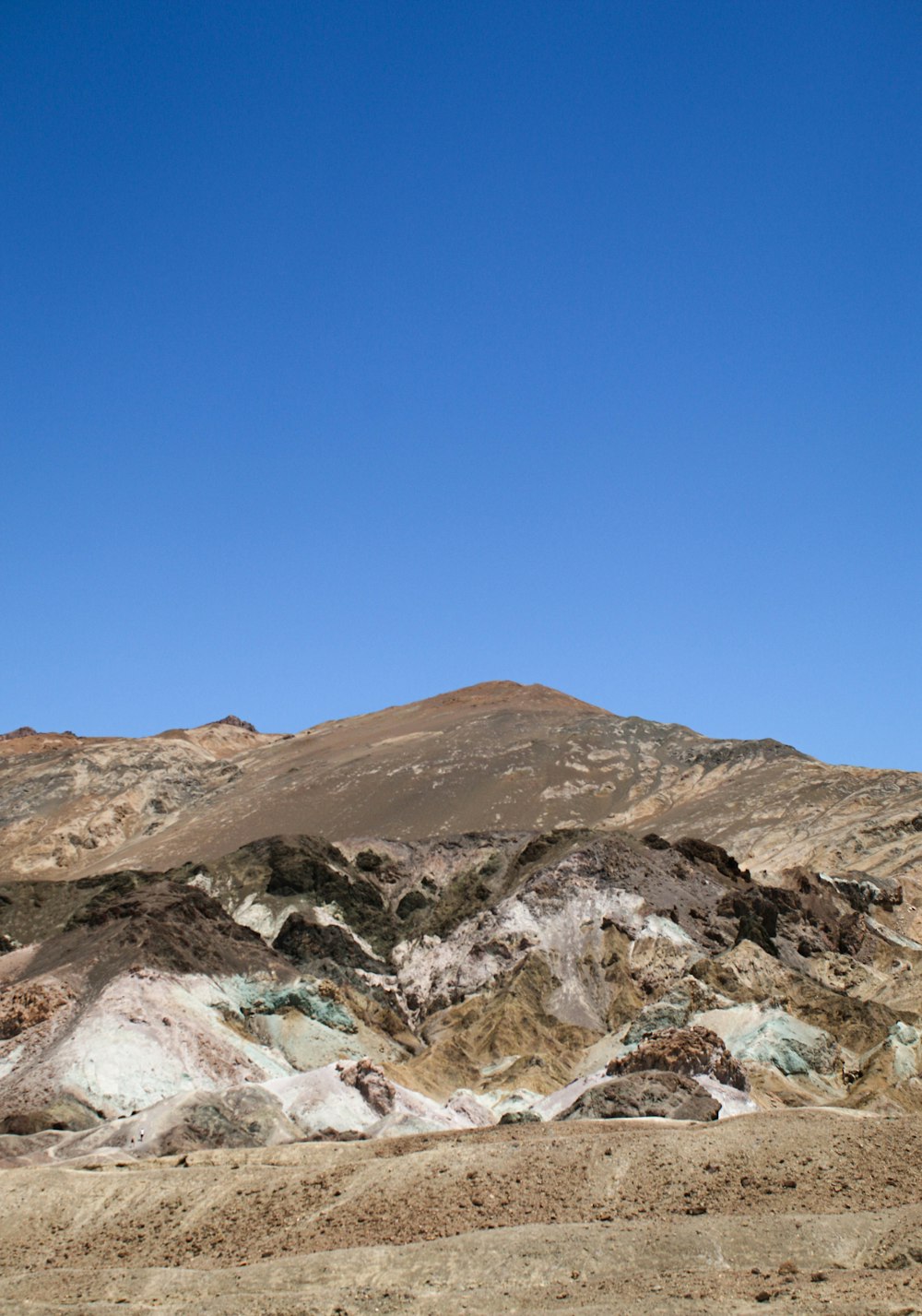 a mountain range with a blue sky in the background