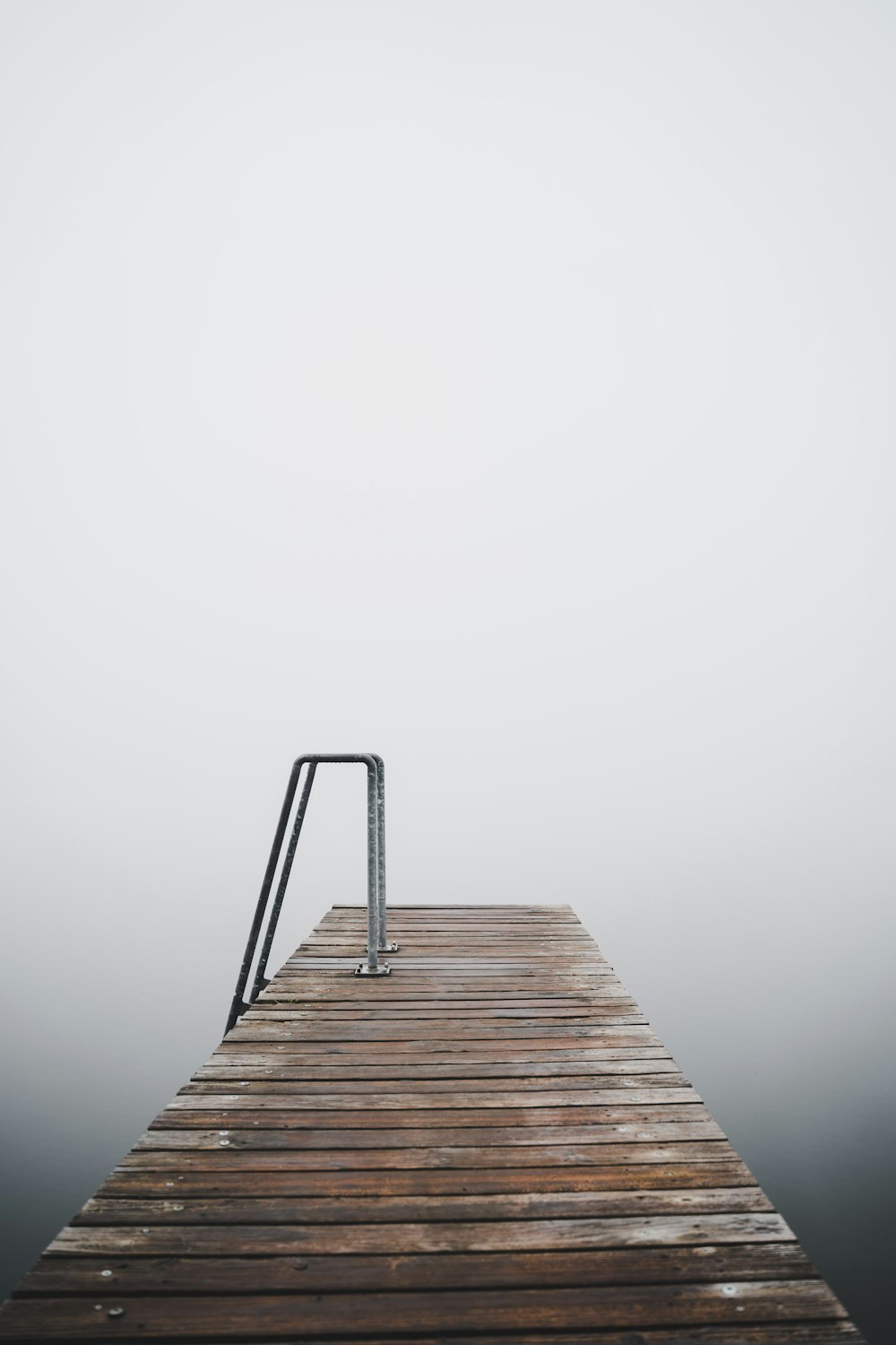 a wooden dock in the middle of a body of water