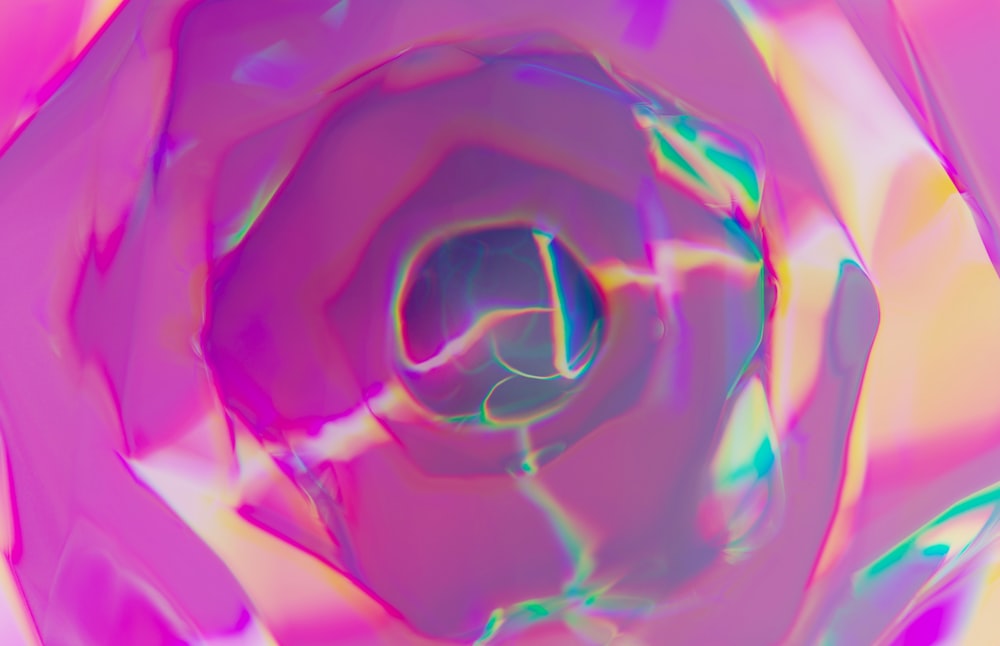 a close up of a pink and blue flower
