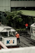 a man standing next to a train on a train track