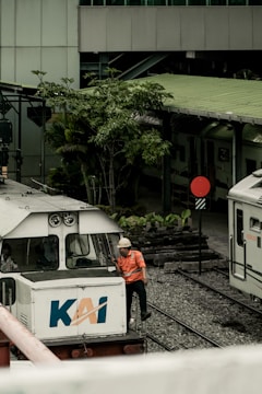 a man standing next to a train on a train track