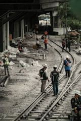 a group of people standing on top of train tracks