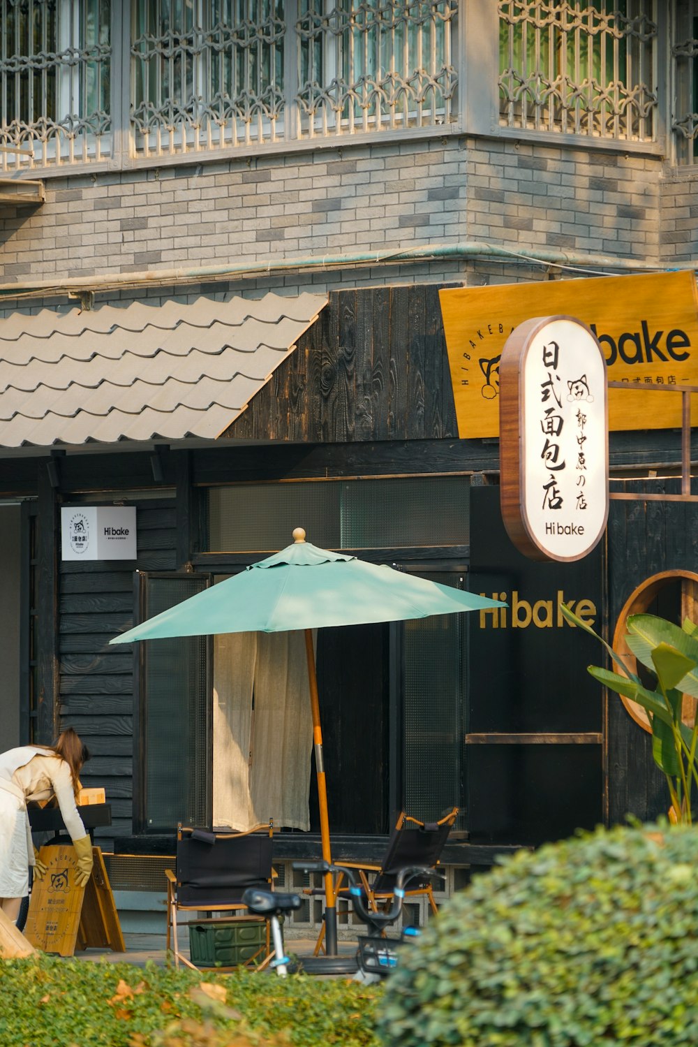 a person sitting at a table with an umbrella