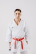 a man in a white karate suit posing for a picture