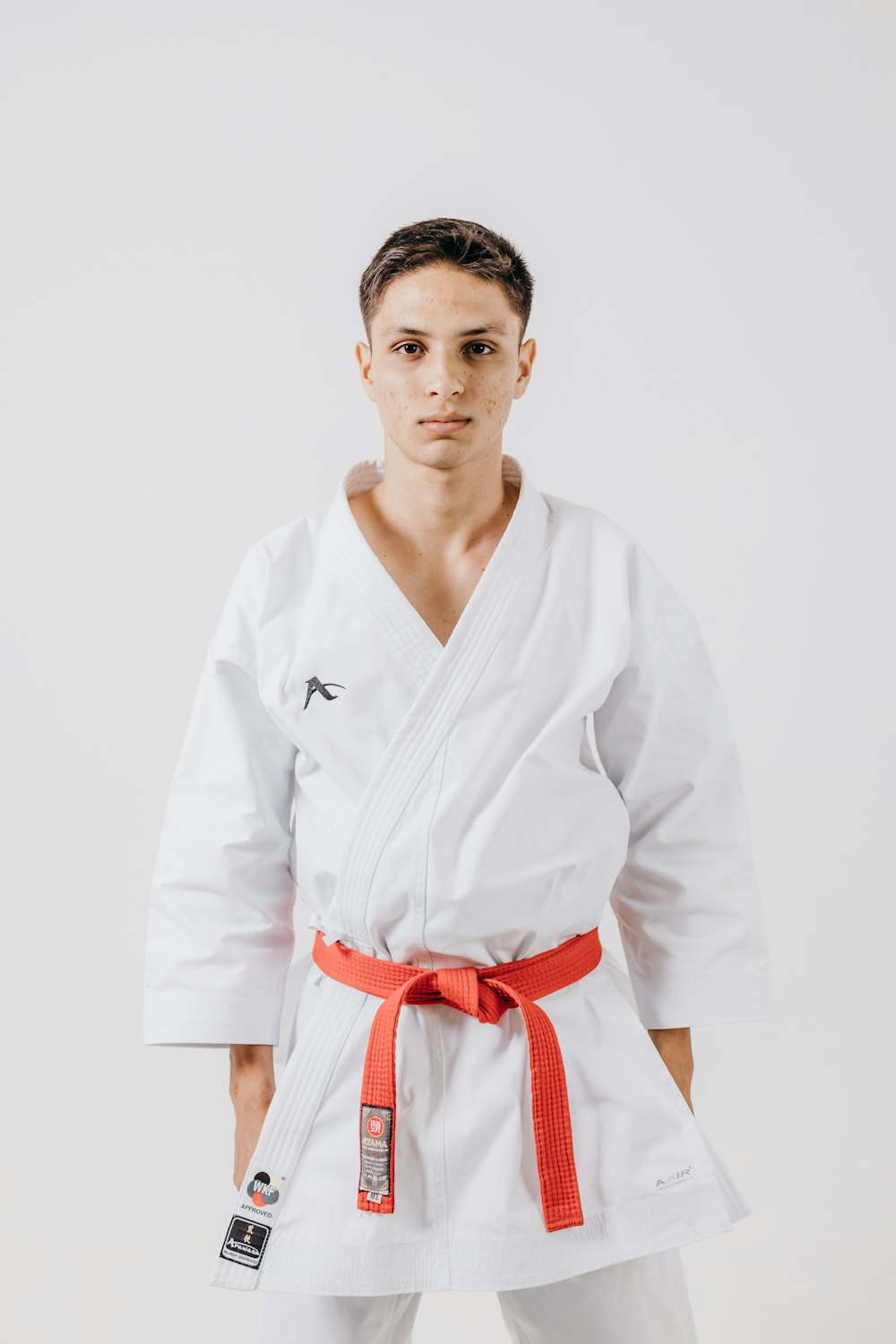 a man in a white karate suit posing for a picture