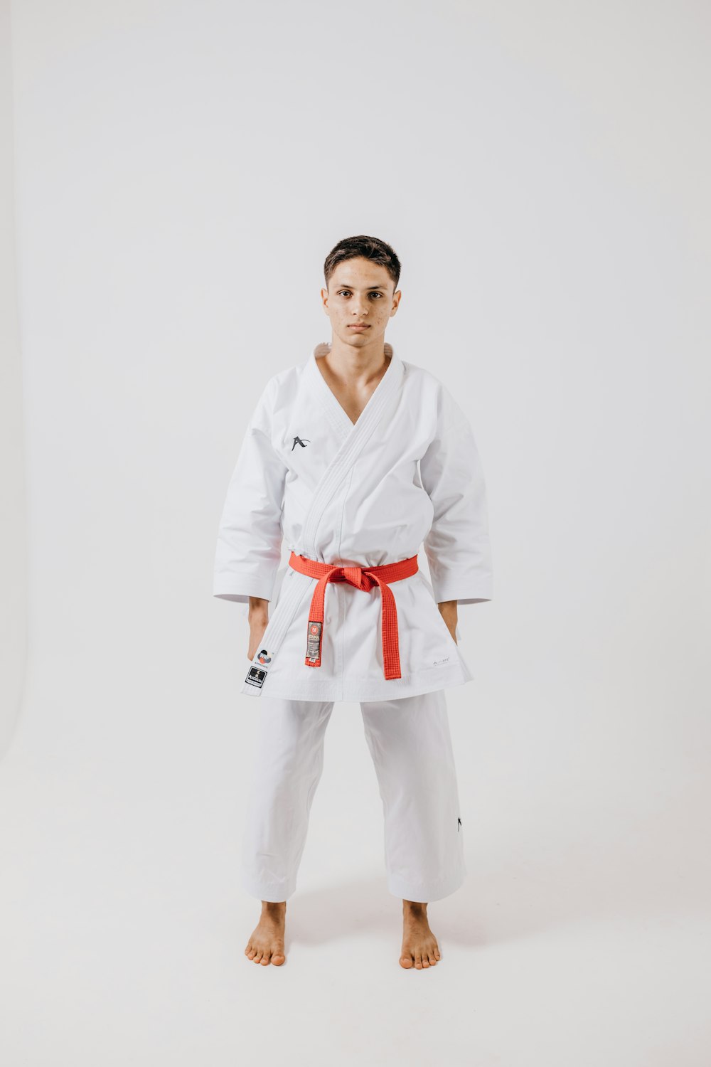 a man in a white karate suit posing for a picture