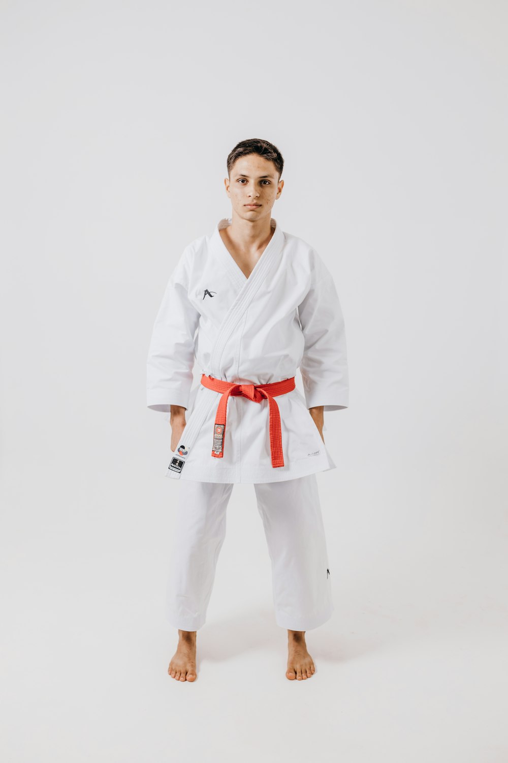 a man standing in a white karate outfit