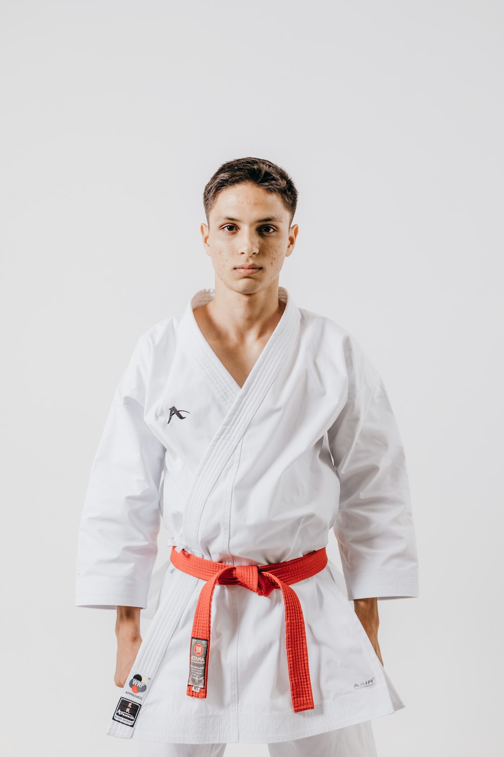 a man in a white karate suit posing for a picture