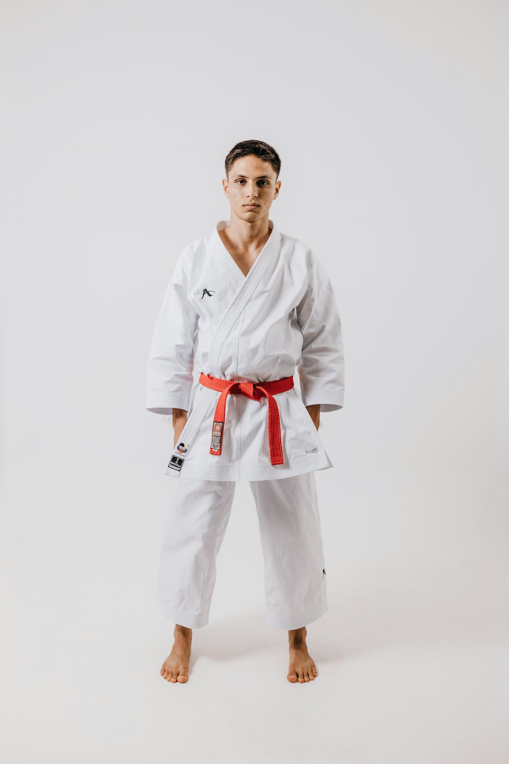 a man in a white karate suit posing for a picture