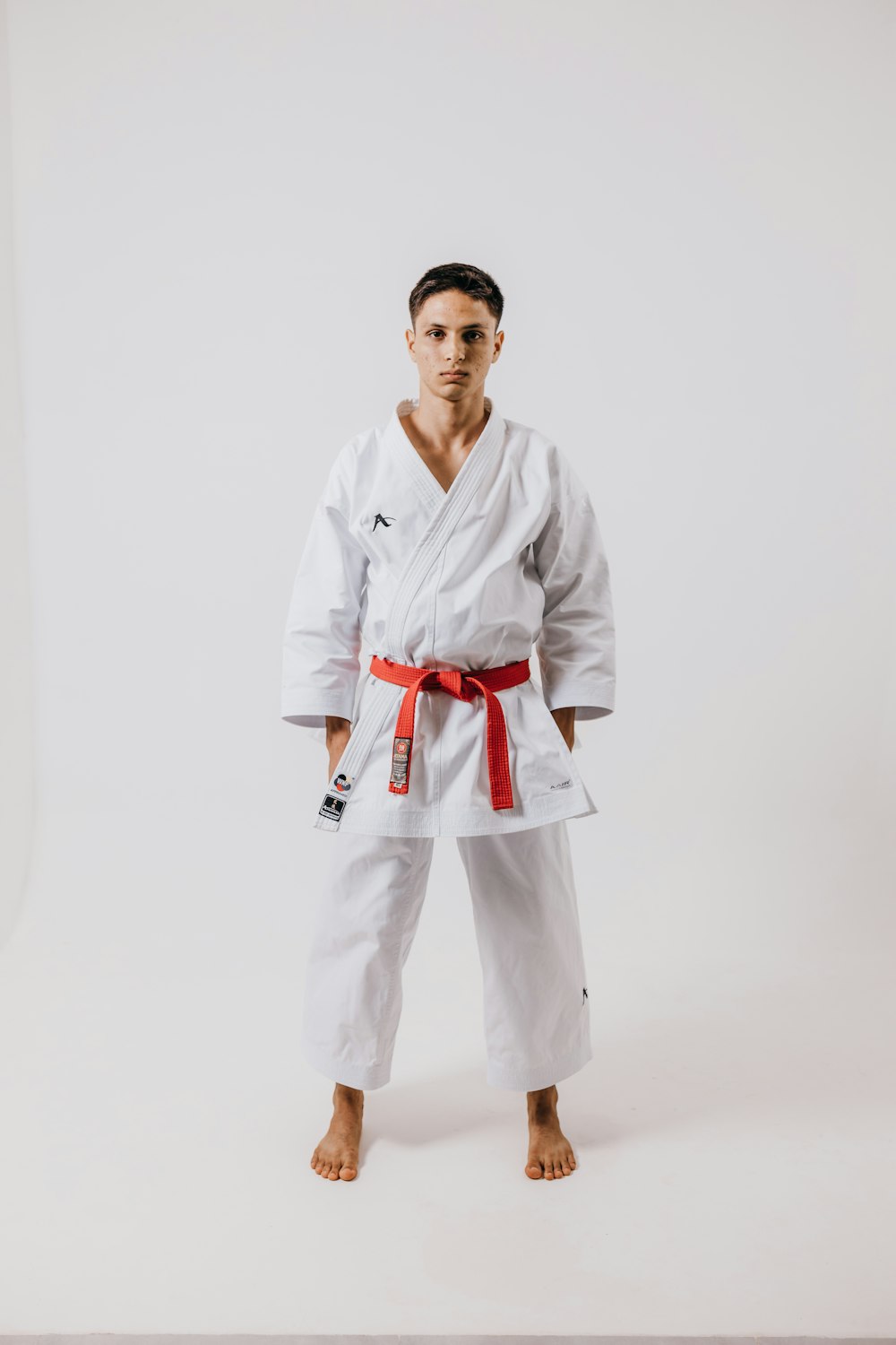 a man standing in a white karate suit