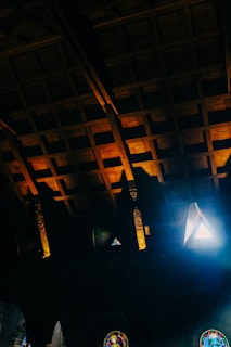 Soft-focus image of a quiet chapel window casting colorful light onto a prayer bench.