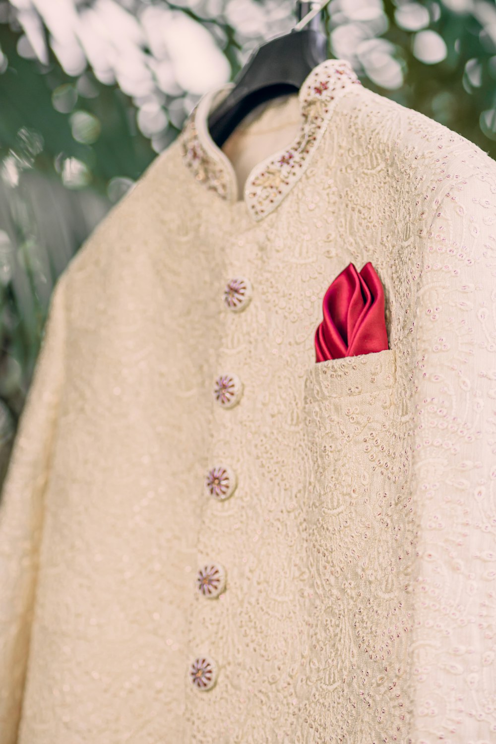 a white jacket with a red flower on it