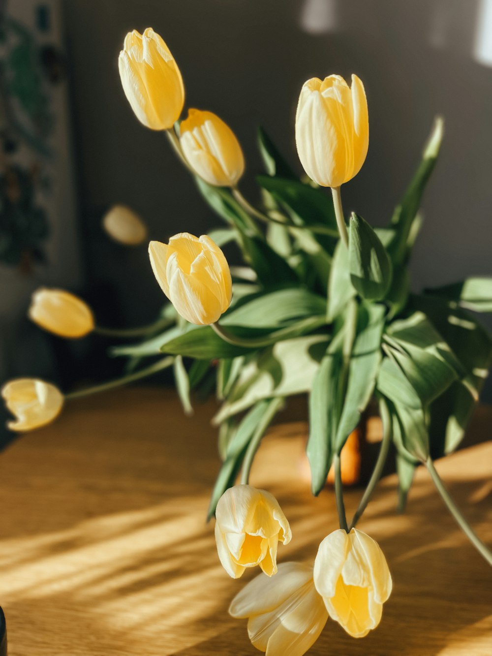 a bouquet of yellow tulips on a table