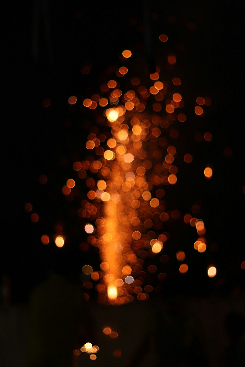 a blurry photo of a firework at night