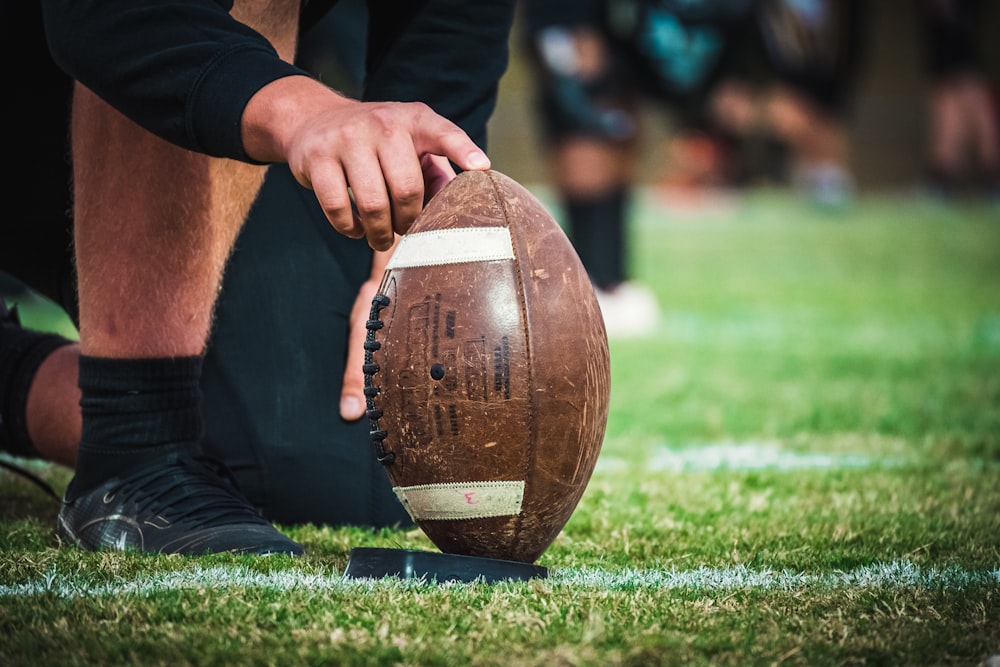 a close up of a person holding a football