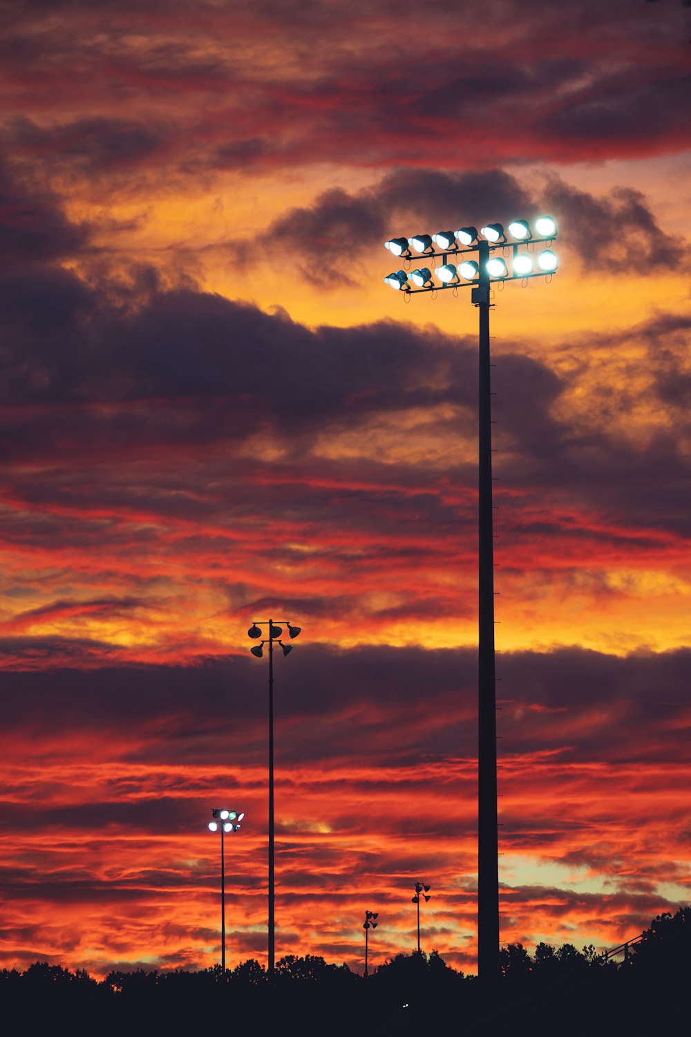 a red and yellow sky with some street lights