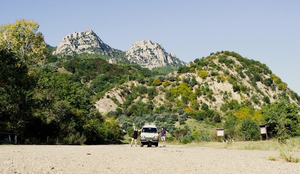 a truck parked on the side of a dirt road