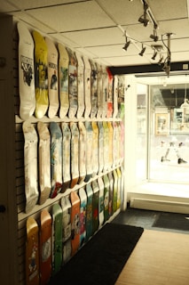 A wide-angle view of the shop interior showing racks filled with decks, gear, and skate accessories.