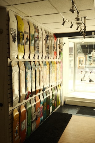 A wide-angle view of the shop interior showing racks filled with decks, gear, and skate accessories.