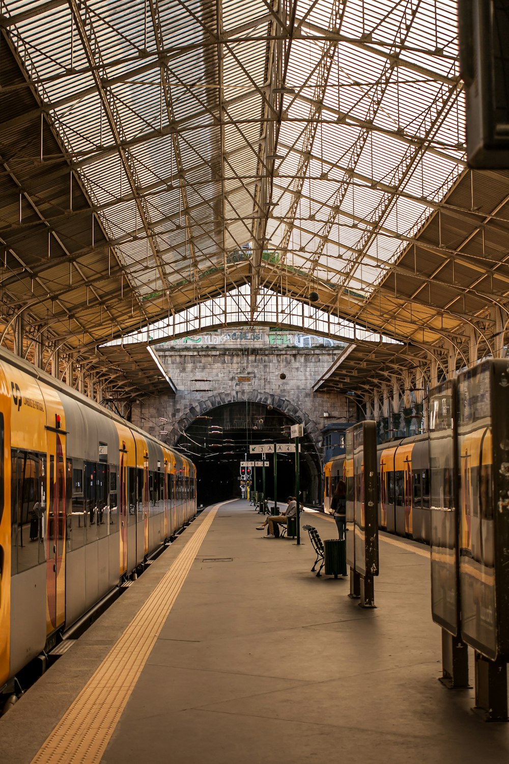 a train station with two trains parked next to each other