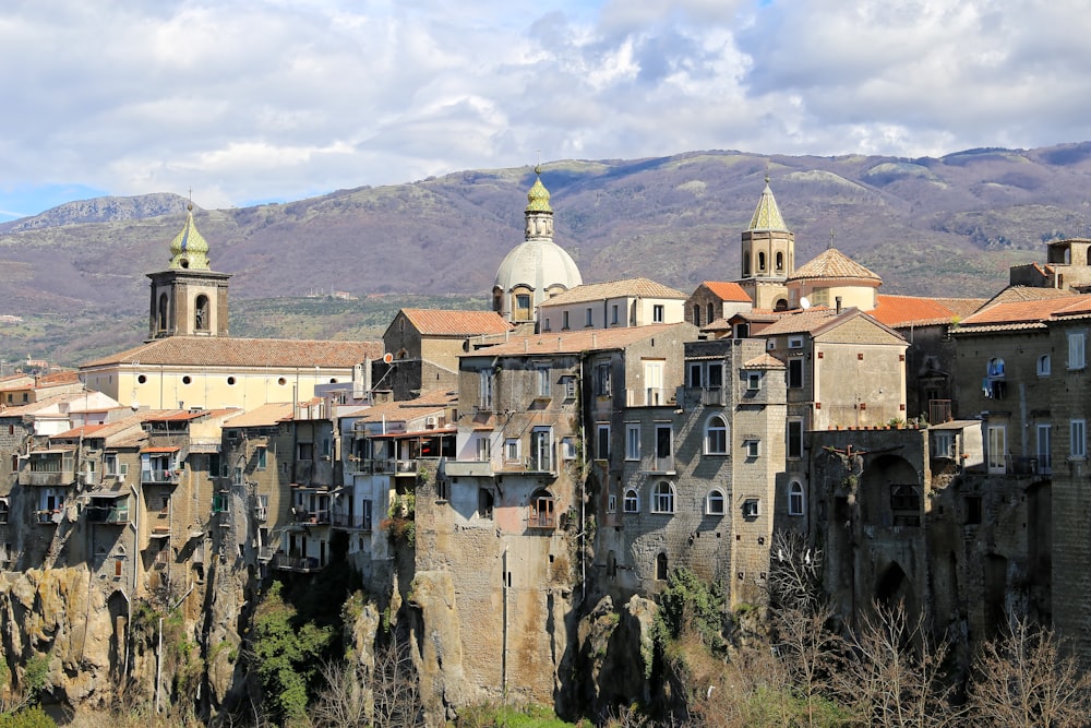 an old city with a mountain in the background