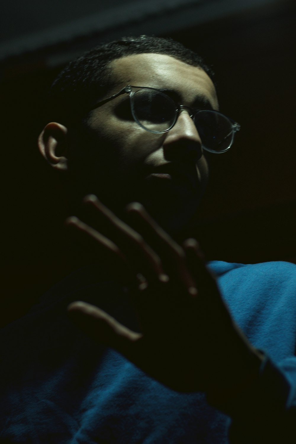 a man in a blue shirt wearing sunglasses