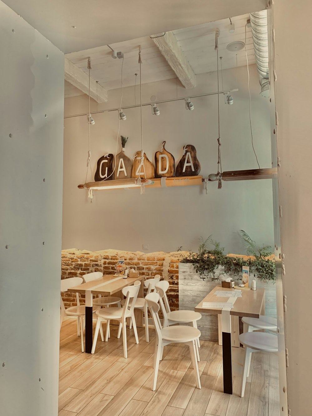 a restaurant with white tables and white chairs