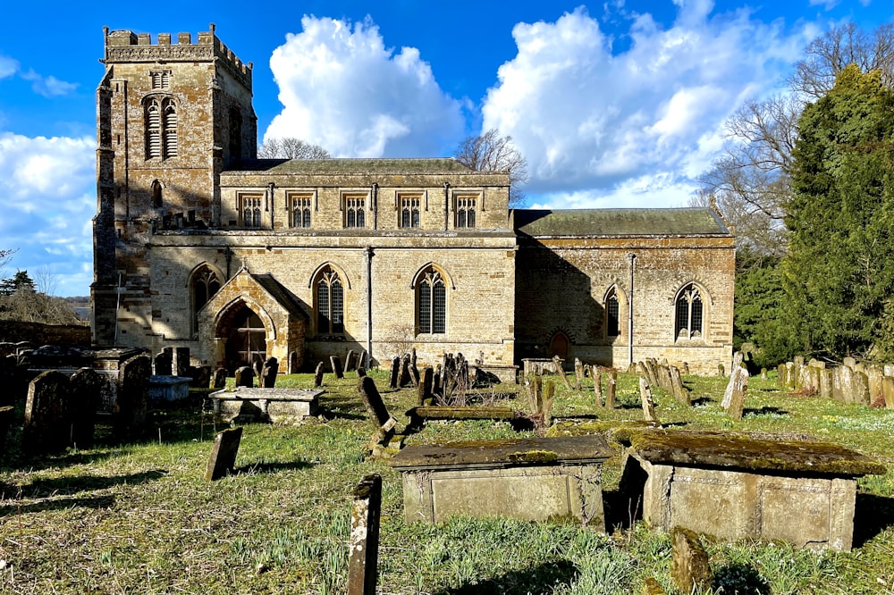 an old church with a graveyard in front of it