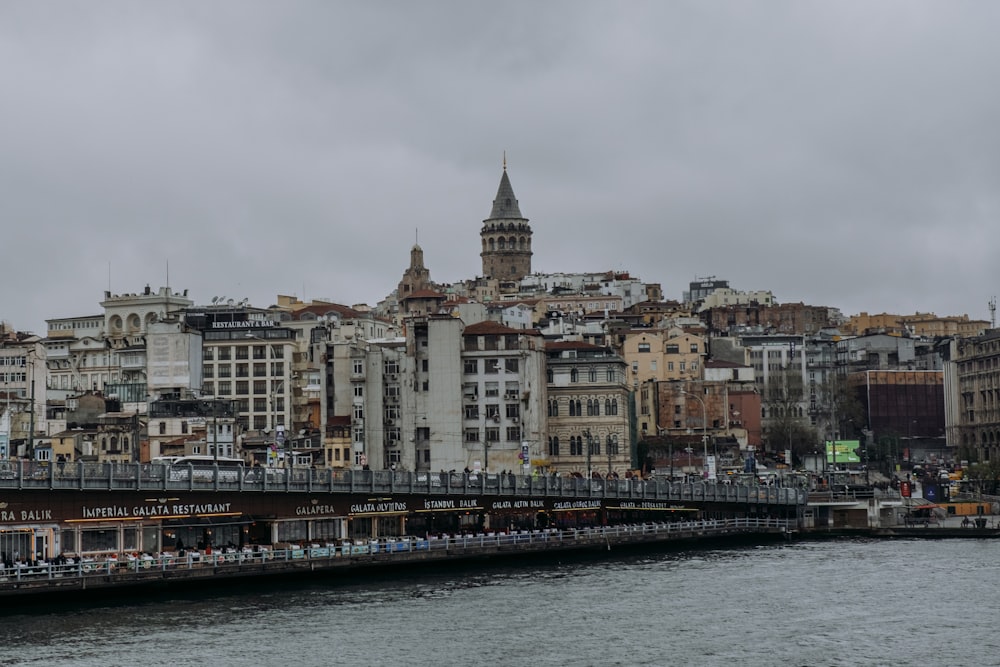 a bridge over a body of water with buildings in the background