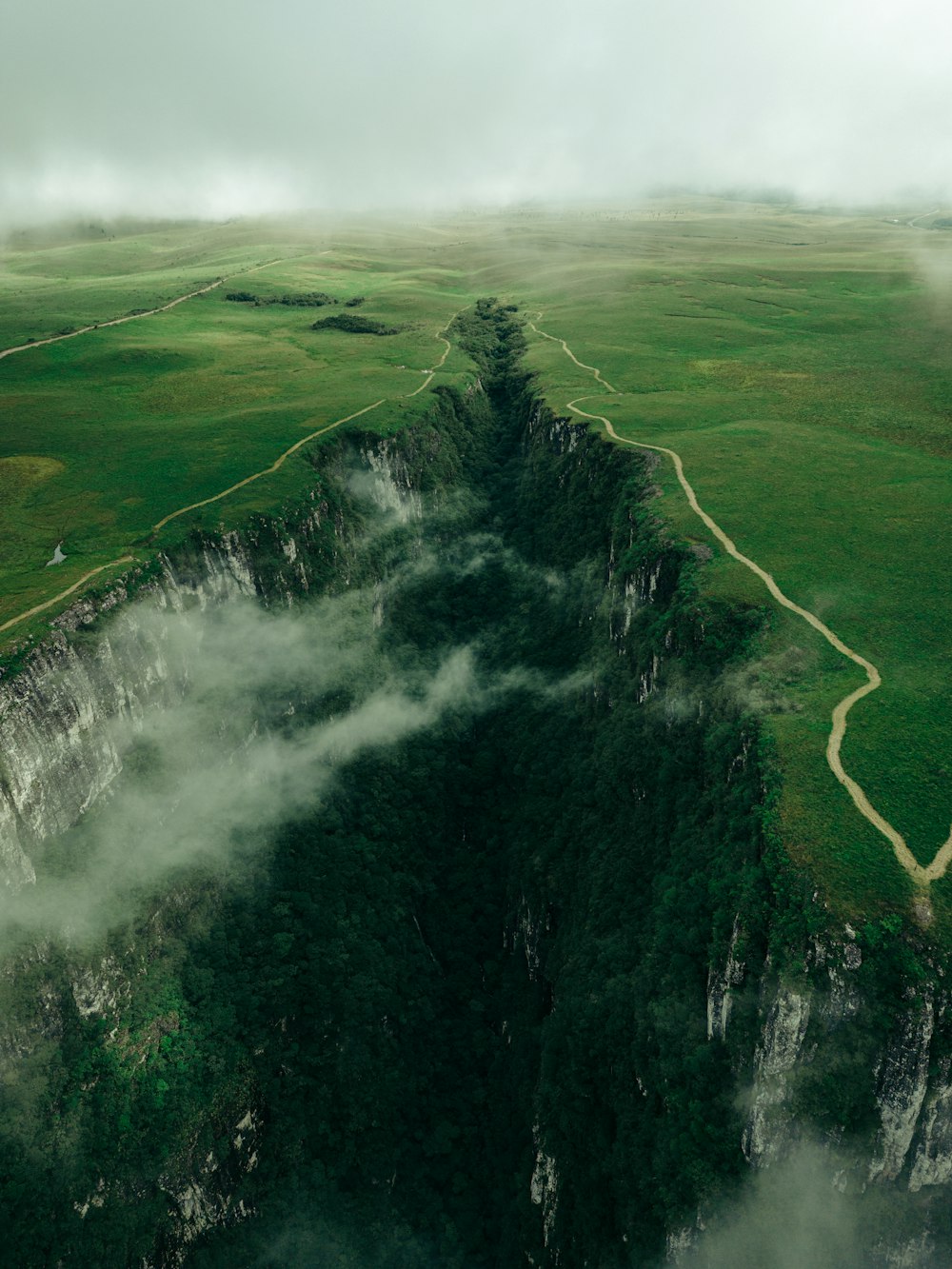 an aerial view of a mountain with a river running through it