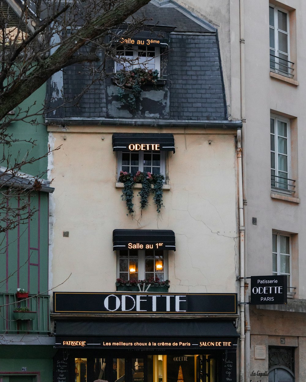 a couple of people walking down a street in front of a building