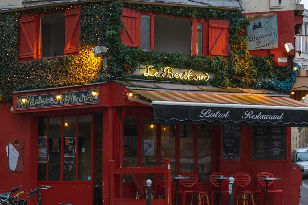 a red building with a green awning and a bike parked in front of it