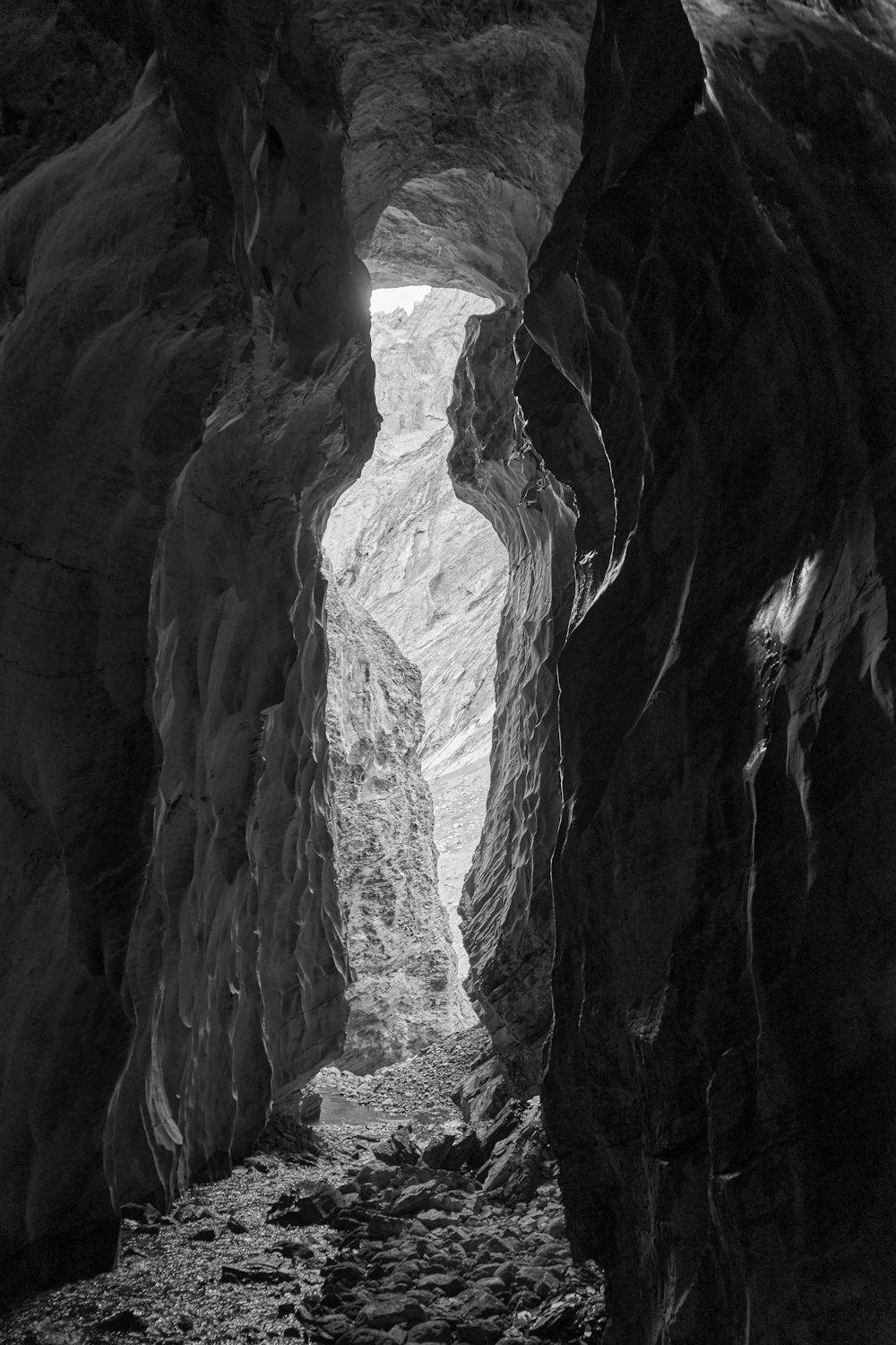 a black and white photo of a narrow tunnel