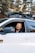 a man wearing sunglasses sitting in a white car
