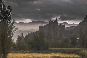 A surreal landscape where ancient ruins meet a stormy, brooding sky.