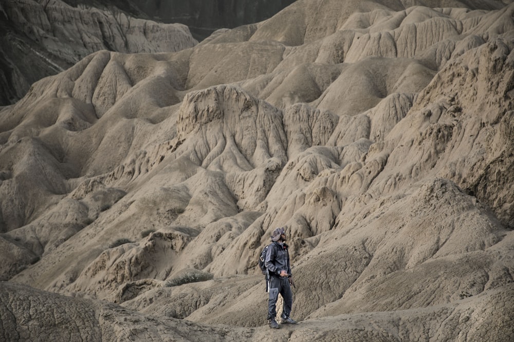 a man standing in the middle of a desert