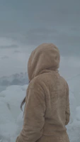 A cozy winter jacket displayed against a snowy backdrop.