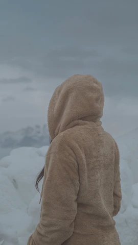 A cozy winter jacket displayed against a snowy backdrop.