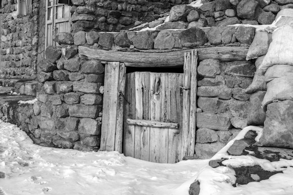 An old wooden door set into the rock — Kandovan, Iran