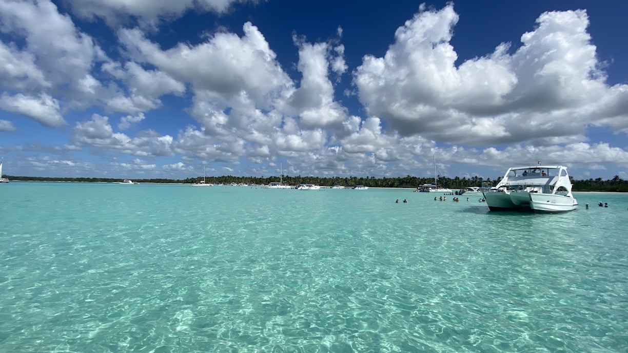 a white boat floating on top of a body of water