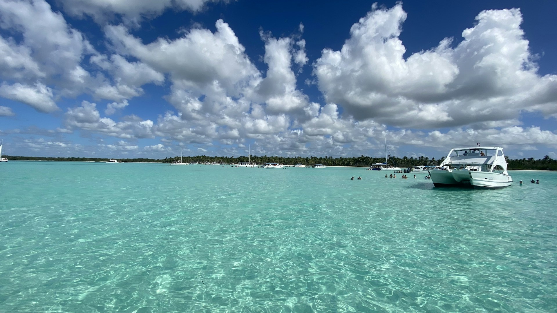 a white boat floating on top of a body of water