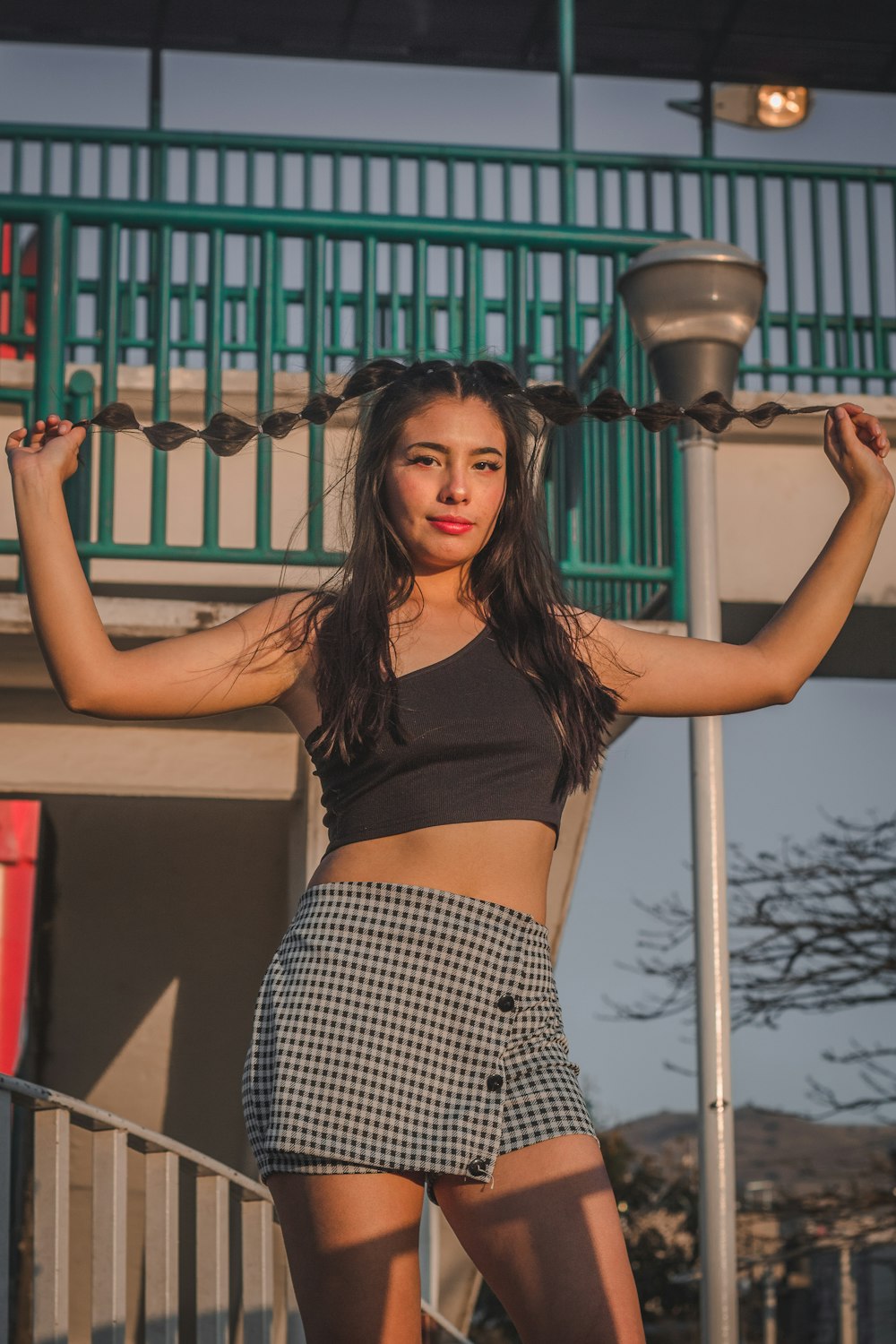 a woman posing for a picture in front of a building