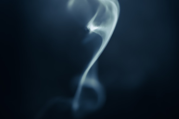 A soft, airy illustration of gentle smoke curling above a cloud-shaped envelope icon.