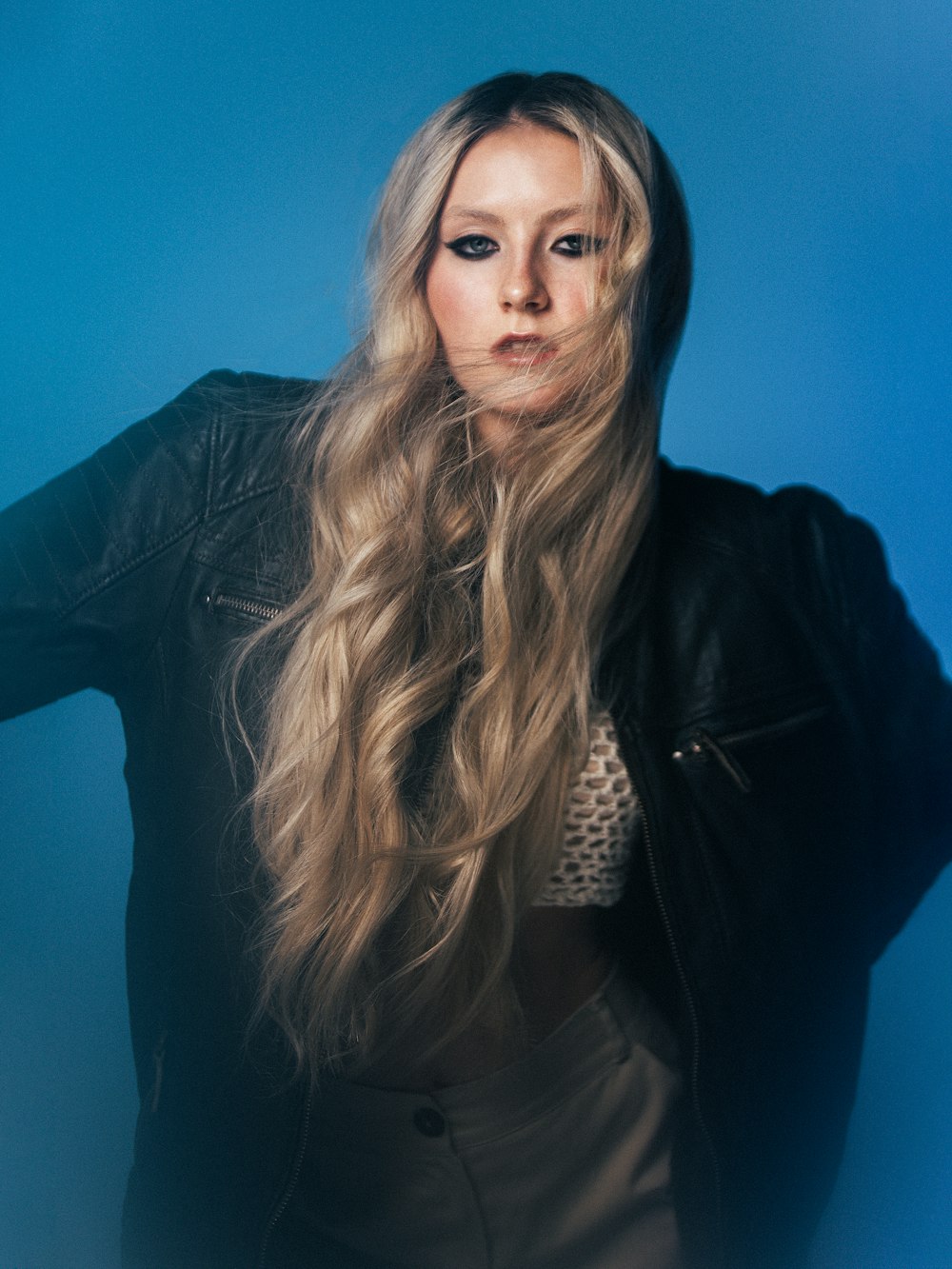 a woman with long blonde hair posing for a picture