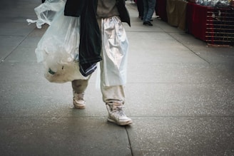 A customer carrying a Mark bag walking confidently through a bustling city street.