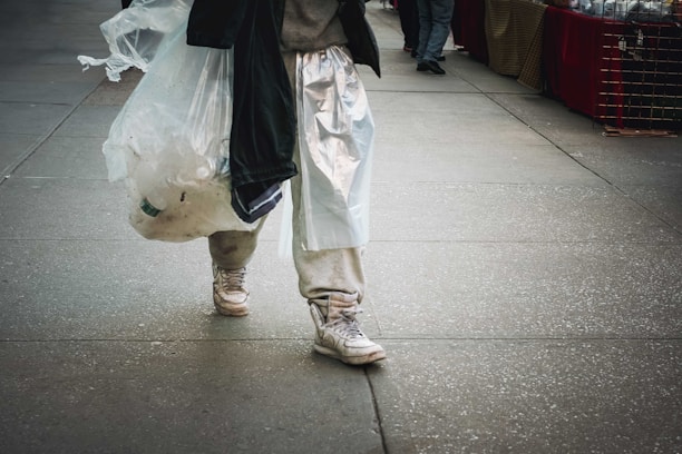 A customer carrying a Mark bag walking confidently through a bustling city street.