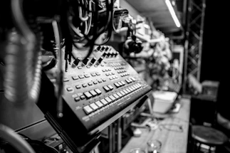 Black-and-white photo of Roberto Randazzo at the mixing console in a dimly lit studio.
