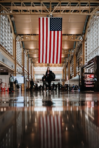 a large american flag hanging from the ceiling of a building