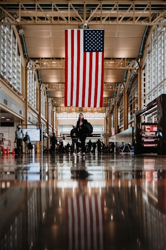 a large american flag hanging from the ceiling of a building
